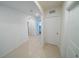 Bright hallway with tiled floors leading to rooms, offering ample natural light at 11517 Koti Creek Ln, Thonotosassa, FL 33592