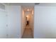 Hallway with carpet, white walls, and doorways leading to rooms and a bathroom visible at the end at 11517 Koti Creek Ln, Thonotosassa, FL 33592