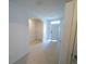 Hallway with tiled floors, leading to rooms, offering a spacious and well-lit path at 11517 Koti Creek Ln, Thonotosassa, FL 33592