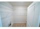 Walk-in closet with white wire shelving and neutral carpet at 11517 Koti Creek Ln, Thonotosassa, FL 33592