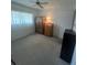 Bright bedroom with carpeted floors, white walls, and ample closet space at 11720 Park Blvd # 104, Seminole, FL 33772