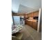 Well-lit kitchen with white appliances, wood cabinets, and tiled countertops at 11720 Park Blvd # 104, Seminole, FL 33772