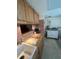 Close up of kitchen with wood cabinets, tile backsplash, and stainless steel sink at 11720 Park Blvd # 104, Seminole, FL 33772