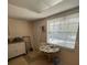 View of the kitchen area with table and chairs by window, and white cabinets at 11720 Park Blvd # 104, Seminole, FL 33772