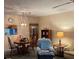 Cozy living room with dining table, comfy armchair, and built-in shelving unit at 11720 Park Blvd # 104, Seminole, FL 33772