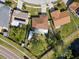 Aerial view of a home with a brown roof and green backyard in a quiet neighborhood at 11803 70Th St, Largo, FL 33773