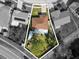 Aerial view of a home with a brown roof and green backyard in a quiet neighborhood at 11803 70Th St, Largo, FL 33773