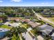 Aerial view of a home with a brown roof and green backyard in a quiet neighborhood at 11803 70Th St, Largo, FL 33773