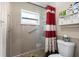 Bright bathroom featuring a shower with glass doors and tiled floors at 11803 70Th St, Largo, FL 33773