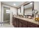 Well-lit bathroom featuring double sinks, granite countertops, and dark wood cabinets at 11803 70Th St, Largo, FL 33773