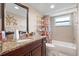A full bathroom with updated granite vanity and framed mirror at 11803 70Th St, Largo, FL 33773