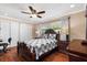 Cozy bedroom featuring hardwood floors, a ceiling fan, and a queen-sized bed at 11803 70Th St, Largo, FL 33773