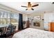 Bedroom boasts natural light, dark hardwood floors, ceiling fan, and built-in fireplace at 11803 70Th St, Largo, FL 33773