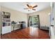 Bedroom with hardwood floors, fan, and glass patio doors leading to a backyard area at 11803 70Th St, Largo, FL 33773
