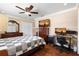 Bedroom featuring hardwood floors, queen sized bed, a ceiling fan, and a workstation at 11803 70Th St, Largo, FL 33773