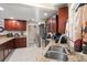Functional kitchen with granite counters, stainless appliances, wooden cabinets and tile flooring at 11803 70Th St, Largo, FL 33773