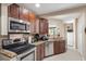 Bright kitchen with stainless appliances, granite countertops, ample cabinetry and white tile flooring at 11803 70Th St, Largo, FL 33773