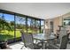 Screened-in patio featuring tile floors and a table with six chairs at 11803 70Th St, Largo, FL 33773