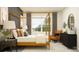 Cozy bedroom with a four-poster bed, stylish decor, and ample natural light at 12553 Lily Quartz Loop, Parrish, FL 34219