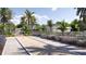 View of the community bocce ball court and playground, surrounded by lush landscaping and palm trees at 12553 Lily Quartz Loop, Parrish, FL 34219