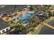 Overhead view of a winding community pool and spa, surrounded by lush landscaping and lounge chairs at 12553 Lily Quartz Loop, Parrish, FL 34219