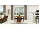 Inviting dining area with a modern table, ample natural light, and stylish decor at 12553 Lily Quartz Loop, Parrish, FL 34219
