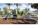 Colorful community playground with slides and climbing structures, surrounded by swaying palm trees at 12553 Lily Quartz Loop, Parrish, FL 34219