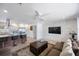 Comfortable living room boasts a large TV, modern lighting, and a tiled wall for design and texture at 13415 Andova Dr, Largo, FL 33774