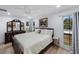 Charming main bedroom with a large bed, modern decor, bright light and large windows at 13415 Andova Dr, Largo, FL 33774