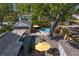 Backyard aerial view with well-maintained landscaping, large shade tree, above ground pool, patio area, and cozy outdoor seating at 145 38Th Ne Ave, St Petersburg, FL 33704