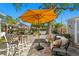 Relaxing backyard patio with a yellow umbrella, comfortable seating, and lush landscaping at 145 38Th Ne Ave, St Petersburg, FL 33704