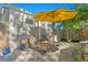 Sunny backyard patio featuring lounge chairs and a vibrant yellow umbrella for shade at 145 38Th Ne Ave, St Petersburg, FL 33704