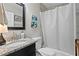 Bright bathroom showcasing granite countertop, classic fixtures and tub with a shower curtain at 145 38Th Ne Ave, St Petersburg, FL 33704