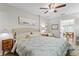 Relaxing bedroom suite with a ceiling fan, a lamp and an arched doorway at 145 38Th Ne Ave, St Petersburg, FL 33704