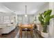 Spacious dining area with hardwood floors, open to kitchen and living room, with modern light fixtures at 145 38Th Ne Ave, St Petersburg, FL 33704