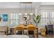 Cozy dining room featuring a wooden table, unique lighting fixtures, and a decorative mirror at 145 38Th Ne Ave, St Petersburg, FL 33704