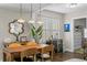 Dining area featuring a wooden table, wine cooler, unique mirror, and modern pendant lighting at 145 38Th Ne Ave, St Petersburg, FL 33704