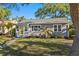 Charming home features a freshly manicured lawn and eye-catching yellow front door at 145 38Th Ne Ave, St Petersburg, FL 33704