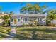 Charming home features a freshly manicured lawn and eye-catching yellow front door at 145 38Th Ne Ave, St Petersburg, FL 33704