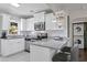 Modern kitchen with white cabinets, stainless steel appliances, and a breakfast bar with granite countertops at 145 38Th Ne Ave, St Petersburg, FL 33704