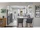 Eat-in kitchen features bright white cabinets, stainless appliances and granite countertops with barstool seating at 145 38Th Ne Ave, St Petersburg, FL 33704