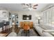 Open-concept living area featuring hardwood floors, modern furniture, and a breakfast bar in the background at 145 38Th Ne Ave, St Petersburg, FL 33704