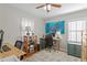 Home office featuring dual desks, an octopus painting, natural light and ample storage space at 145 38Th Ne Ave, St Petersburg, FL 33704