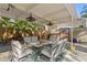 Covered outdoor patio featuring comfortable seating, a ceiling fan, and tropical landscaping for a serene and relaxing atmosphere at 145 38Th Ne Ave, St Petersburg, FL 33704