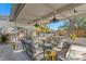 Relaxing covered patio with comfortable seating, ceiling fans, and serene backyard views at 145 38Th Ne Ave, St Petersburg, FL 33704