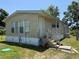 Charming home exterior featuring a covered entryway, manicured lawn, and great curb appeal at 14620 Geneva Dr, Odessa, FL 33556