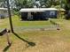 Exterior of the home with a yard featuring a charming white picket fence and mature landscaping at 14620 Geneva Dr, Odessa, FL 33556