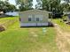 Side view of the home and lawn showcasing the home's exterior and a well-kept yard at 14620 Geneva Dr, Odessa, FL 33556