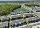 Drone shot exhibits the community next to green spaces and a beautiful pond at 1504 Colt Creek Pl, Wesley Chapel, FL 33543