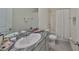 Bathroom features a large mirror, granite countertop, and a shower-tub combo at 1504 Colt Creek Pl, Wesley Chapel, FL 33543